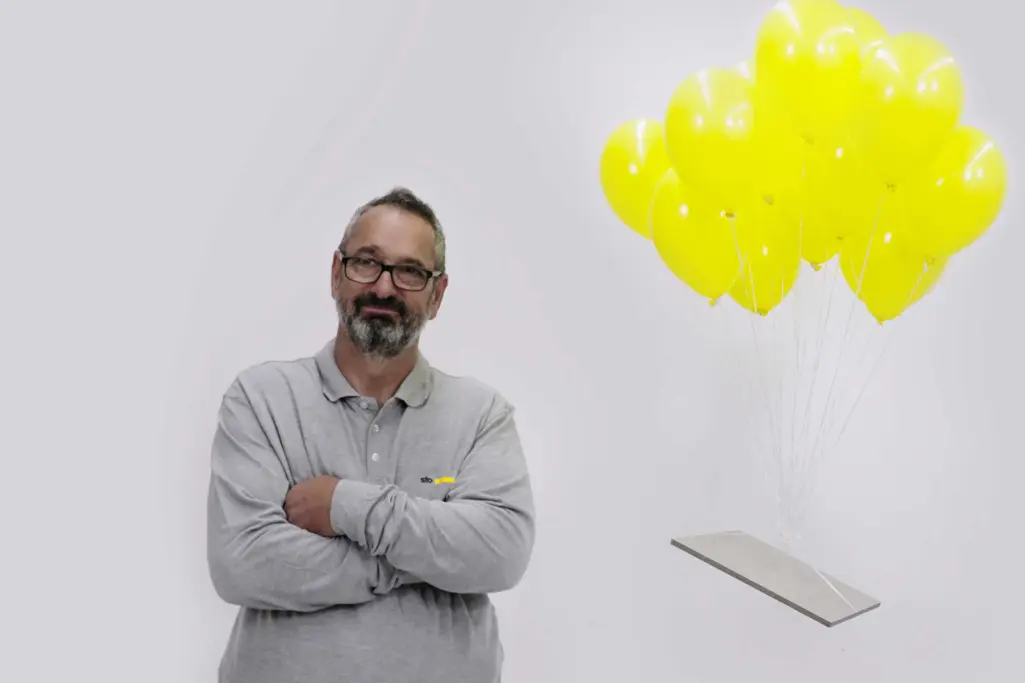 Lightweight render carrier board: Technical Advisor with carrier board tied to yellow balloons