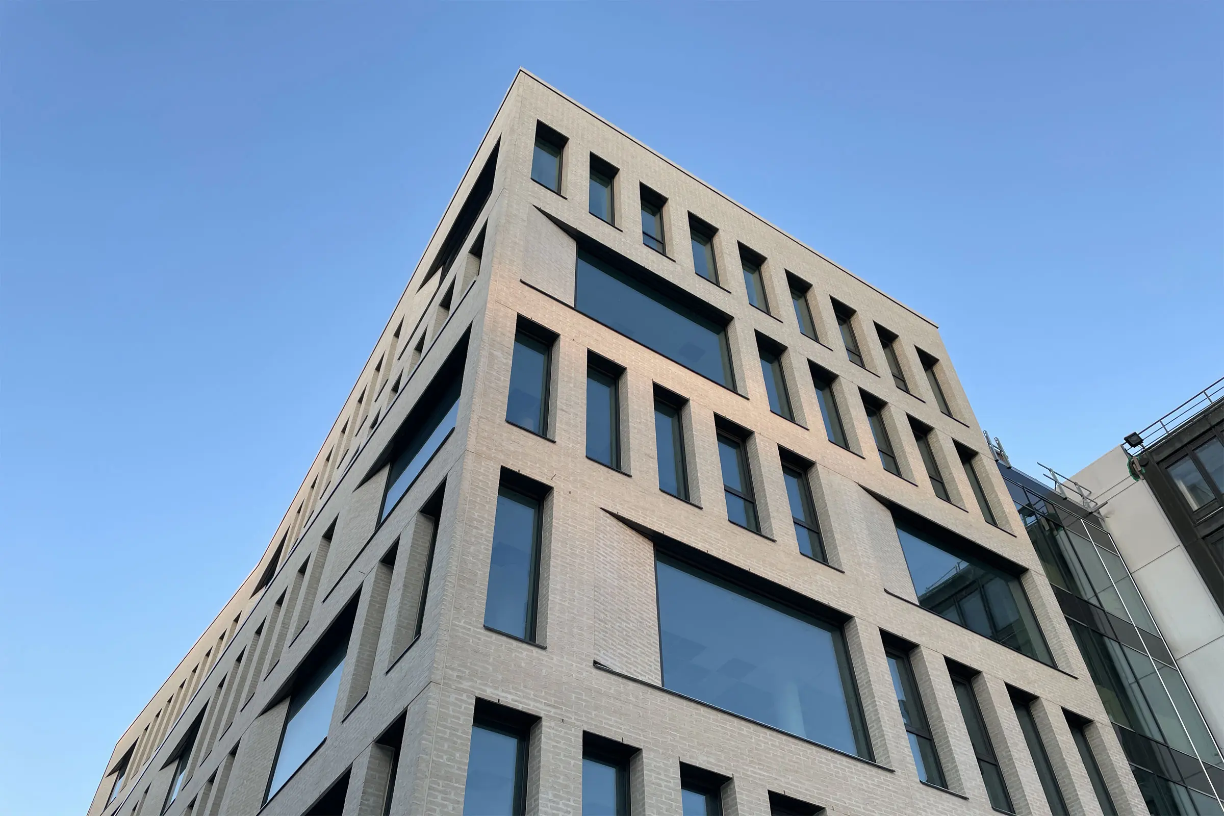 Moderni toimistorakennus vaalealla tiilijulkisivulla