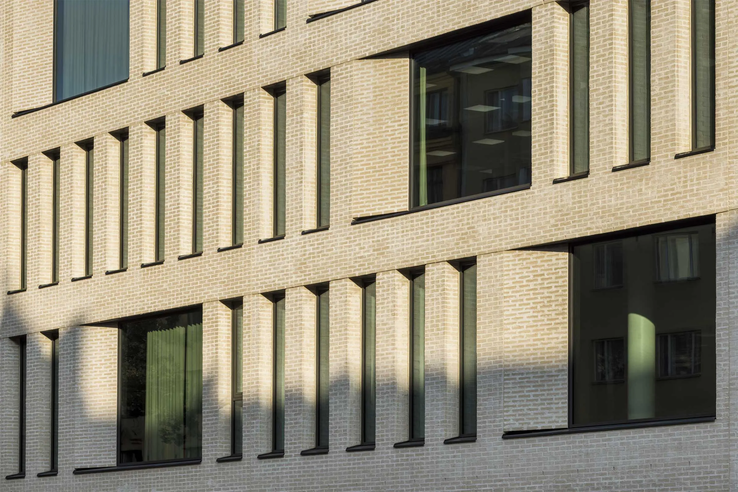 Moderni toimistorakennus vaalealla tiilijulkisivulla